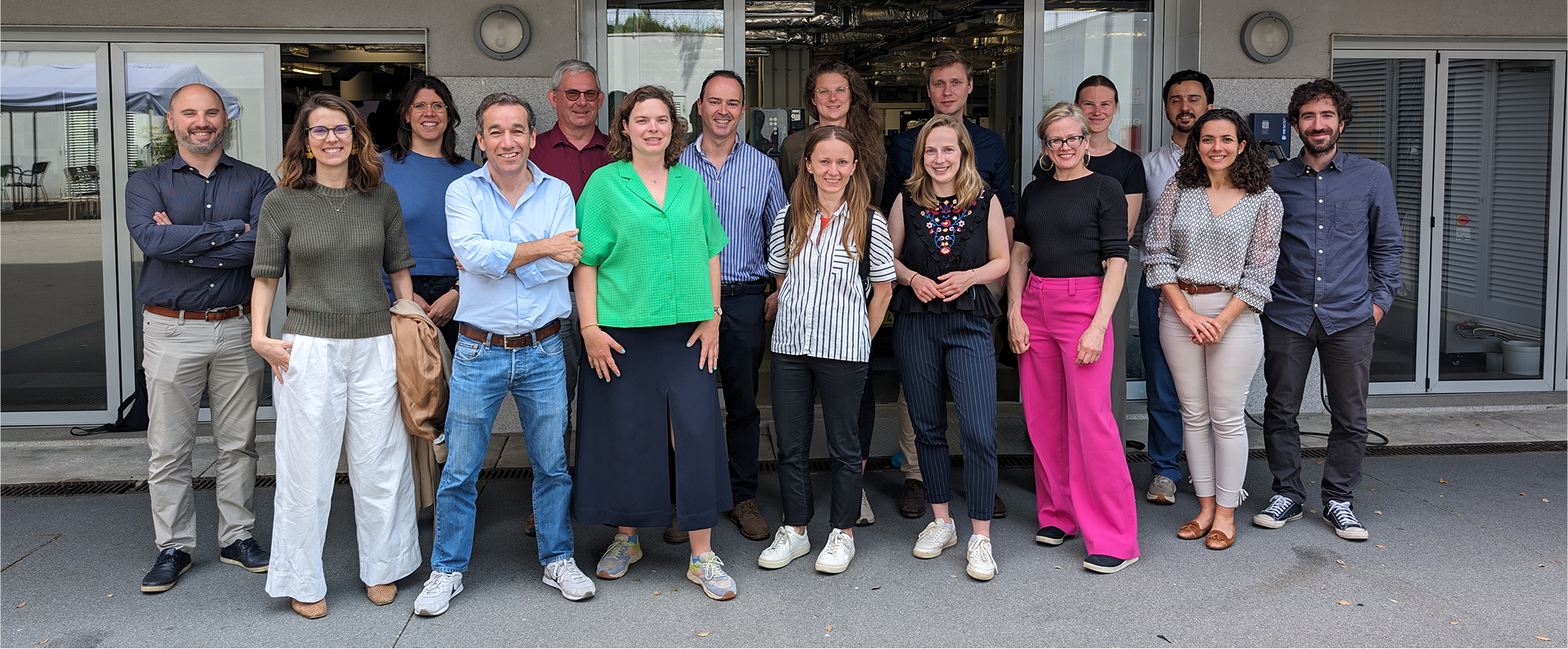 A group of people posing for a photo, smiling at the camera.